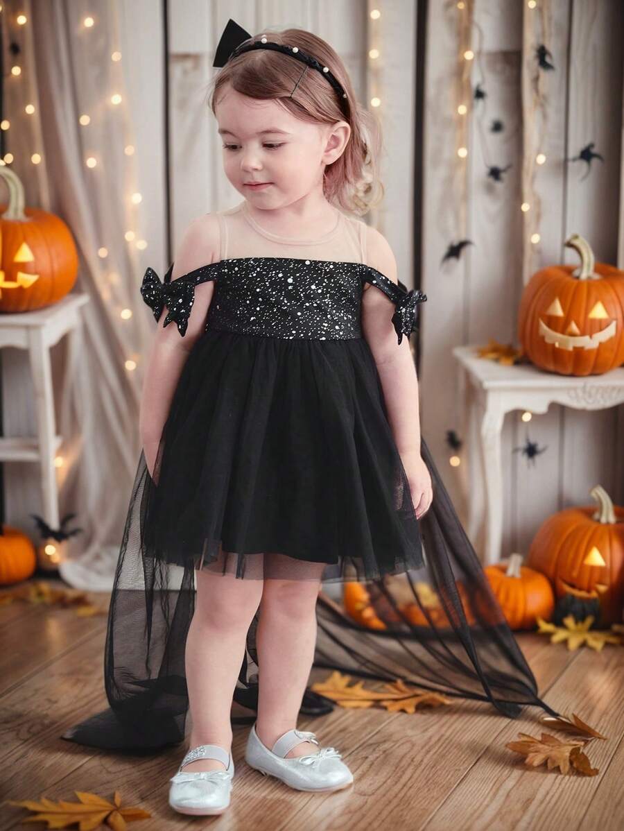 فستان بناتي أنيق من شي إن، باللون الأسود بدون أكمام مع فيونكة من قماش شبكي مزين بالترتر - سن 6 سنوات