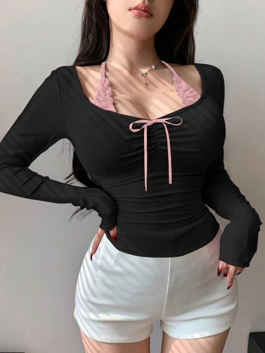 توب نسائي صيفي أسود بأكمام طويلة وخصر مشدود ومزين بفيونكة من ديزي