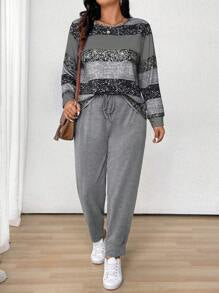 طقم نسائي (قطعتين): بلوزة مخططة بياقة دائرية وأكمام طويلة وبنطلون برباط أمامي من مجموعة لون – شي إن