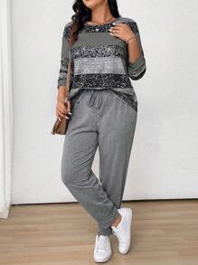 طقم نسائي (قطعتين): بلوزة مخططة بياقة دائرية وأكمام طويلة وبنطلون برباط أمامي من مجموعة لون – شي إن