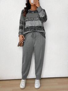 طقم نسائي (قطعتين): بلوزة مخططة بياقة دائرية وأكمام طويلة وبنطلون برباط أمامي من مجموعة لون – شي إن